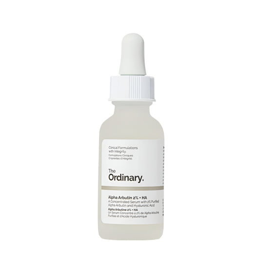 A white dropper bottle of The Ordinary Alpha Arbutin 2% + HA Serum 30ml targets hyperpigmentation, featuring the brand name and product details on the label. The cap includes a dropper for application against a plain white background.