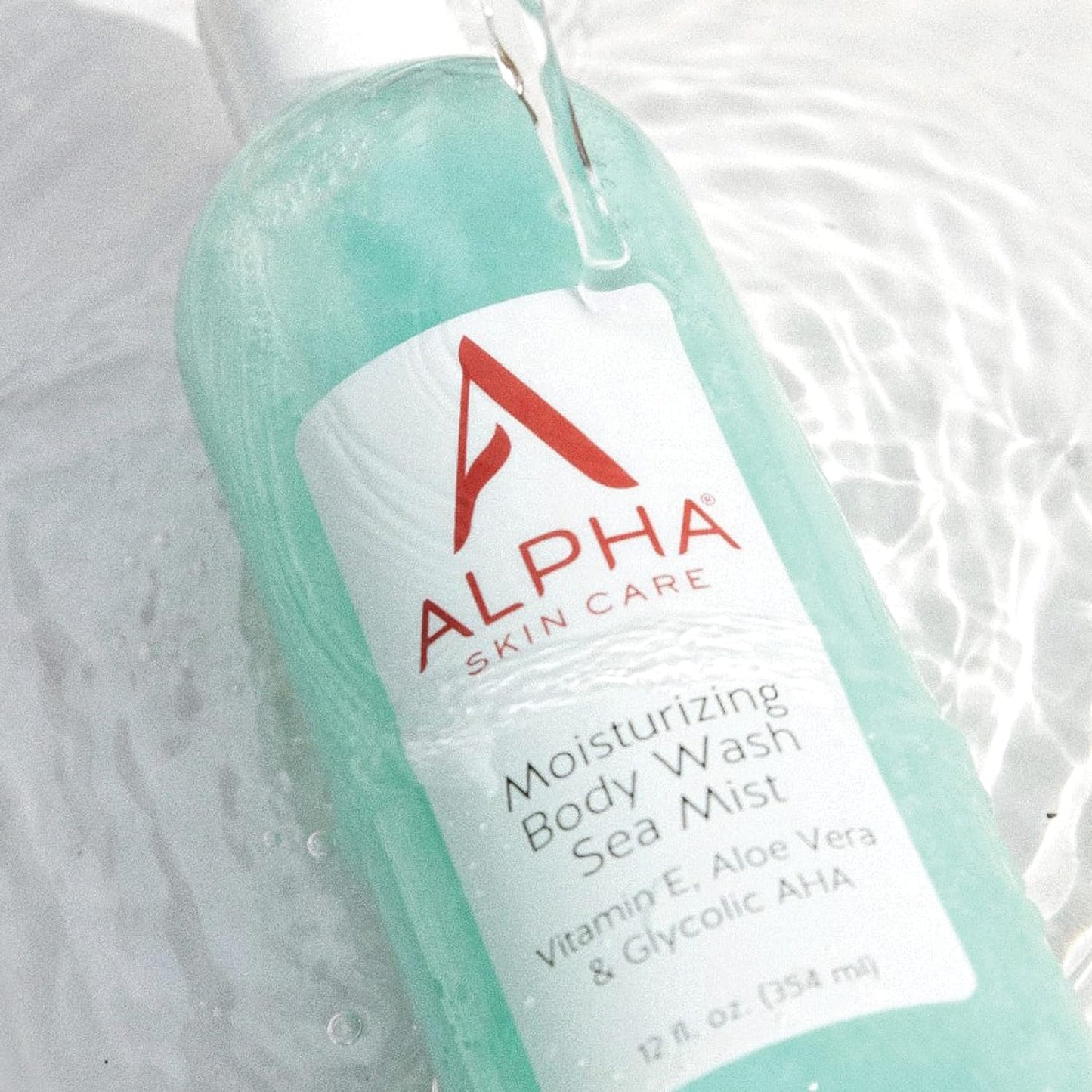 Alpha Skin Care moisturizing body wash bottle with water droplets on a light background