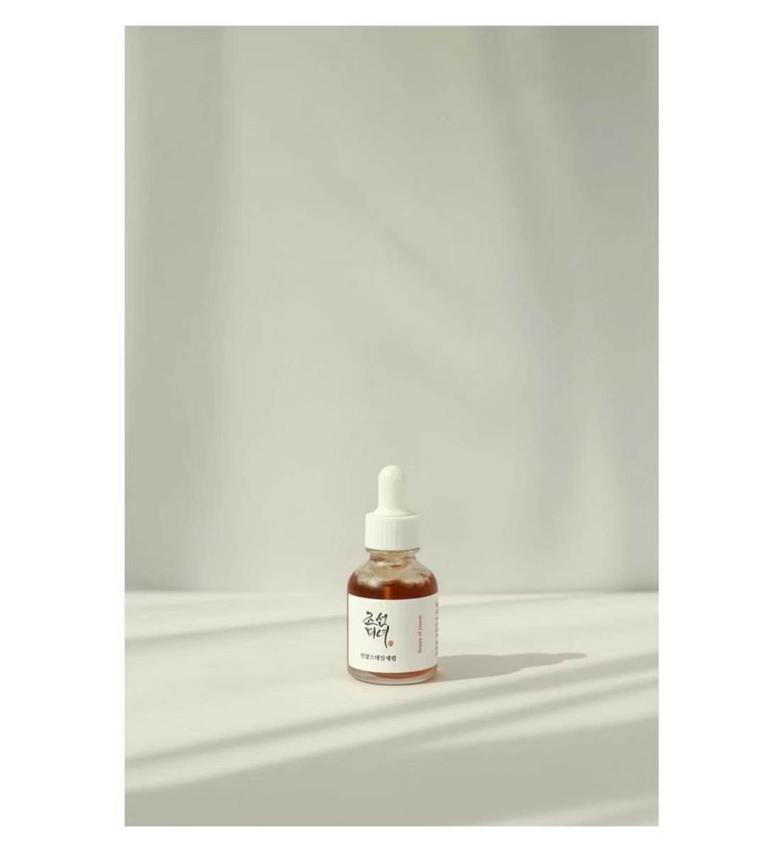 Bottle with dropper on a neutral background
