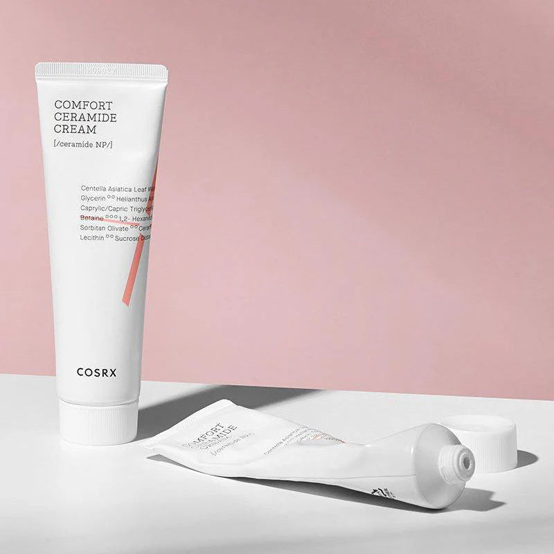 Cosrx Comfort Ceramide Cream tube on a light pink background