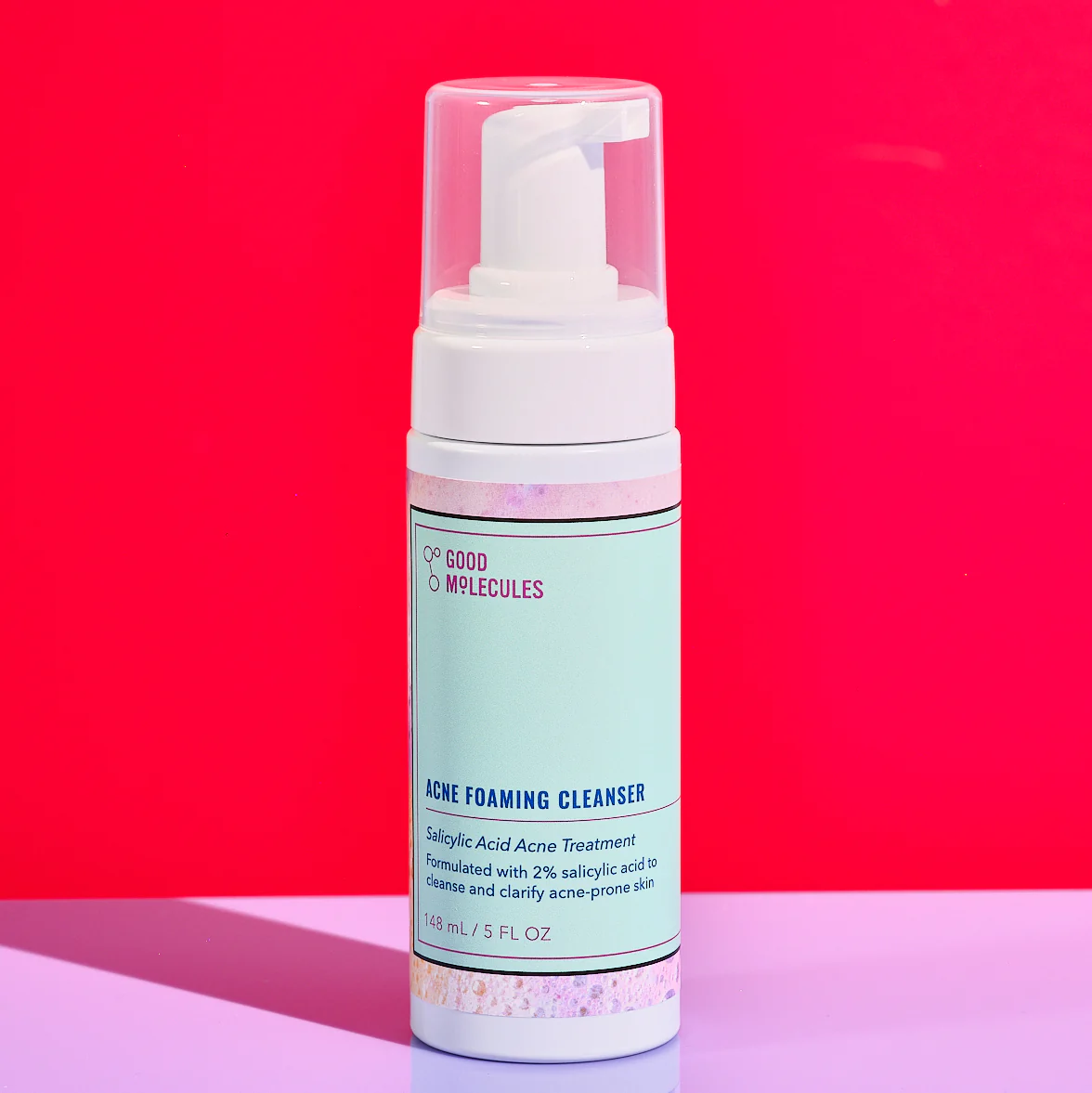Good Molecules Acne Foaming Cleanser with Salicylic Acid BHA (148ml) features a pump dispenser and a gradient red-pink background, offering an effective acne treatment for clearer skin.