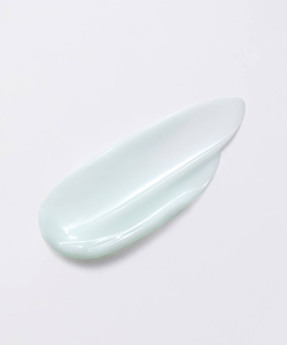 A glossy, pale mint green ceramic dish with a smooth, elongated oval shape holds a Laneige Water Sleeping Mask - 70ml by LANEIGE, resting serenely on a white background.