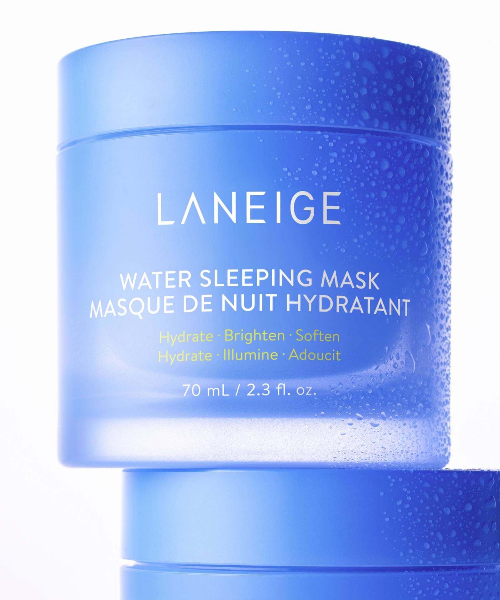 Two blue containers of LANEIGEs 70ml Water Sleeping Mask are stacked, showcasing English and French text about its hydrating, brightening, and softening benefits with a Probiotics-derived complex. The dew-like texture enhances the overnight mask experience.