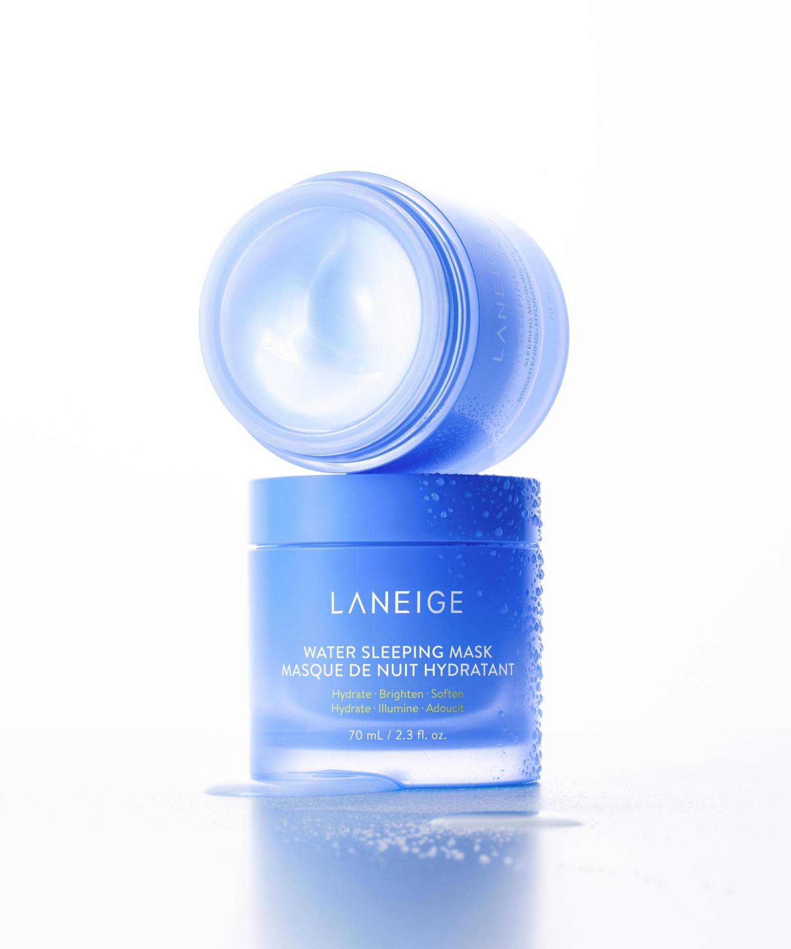 A blue LANEIGE Water Sleeping Mask - 70ml container is open, showcasing the mask inside. The text describes this hydrating overnight mask as infused with a probiotics-derived complex for hydration, brightness, and softness, with the container looking slightly dewy.