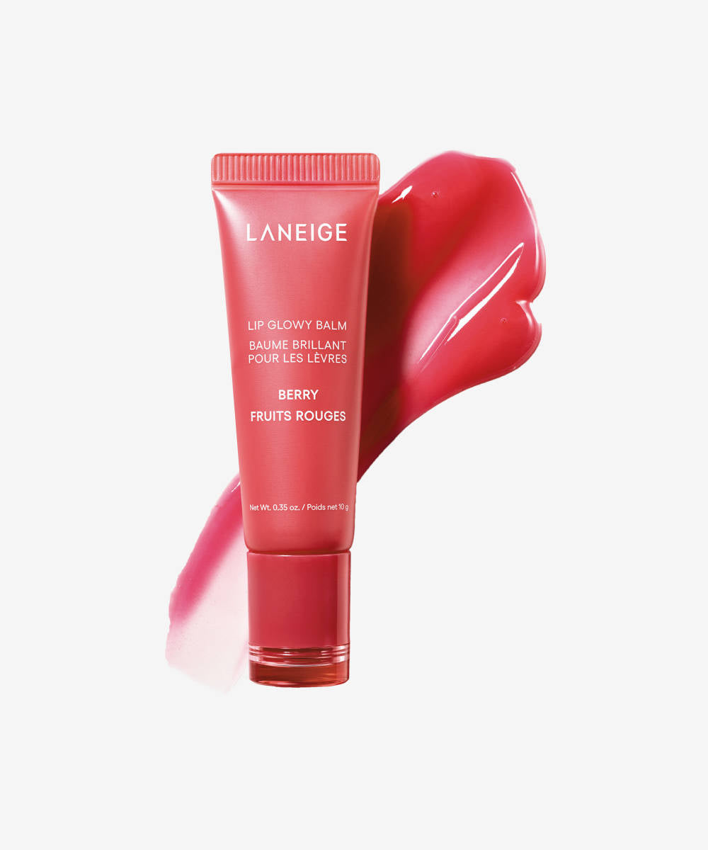 A red tube of Laneige Lip Glowy Balm - Berry 10g enriched with shea and murumuru butters stands upright, a pink balm smudge beside it, against a white background.