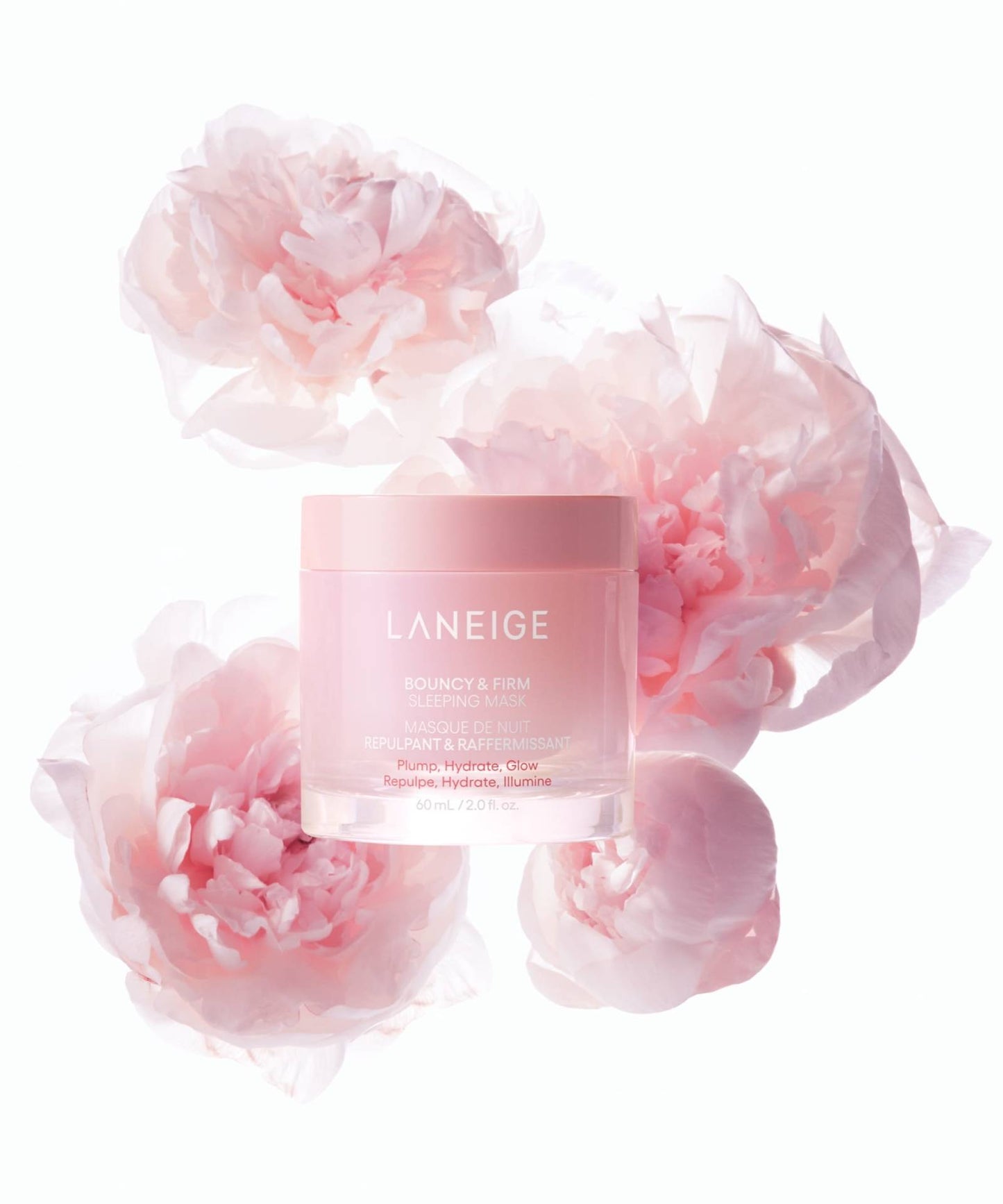 A jar of Laneige Bouncy & Firm Sleeping Mask - 60ml is surrounded by soft pink peonies. The mask promises to plump, hydrate, and enhance skin radiance. The background is a light, neutral color.