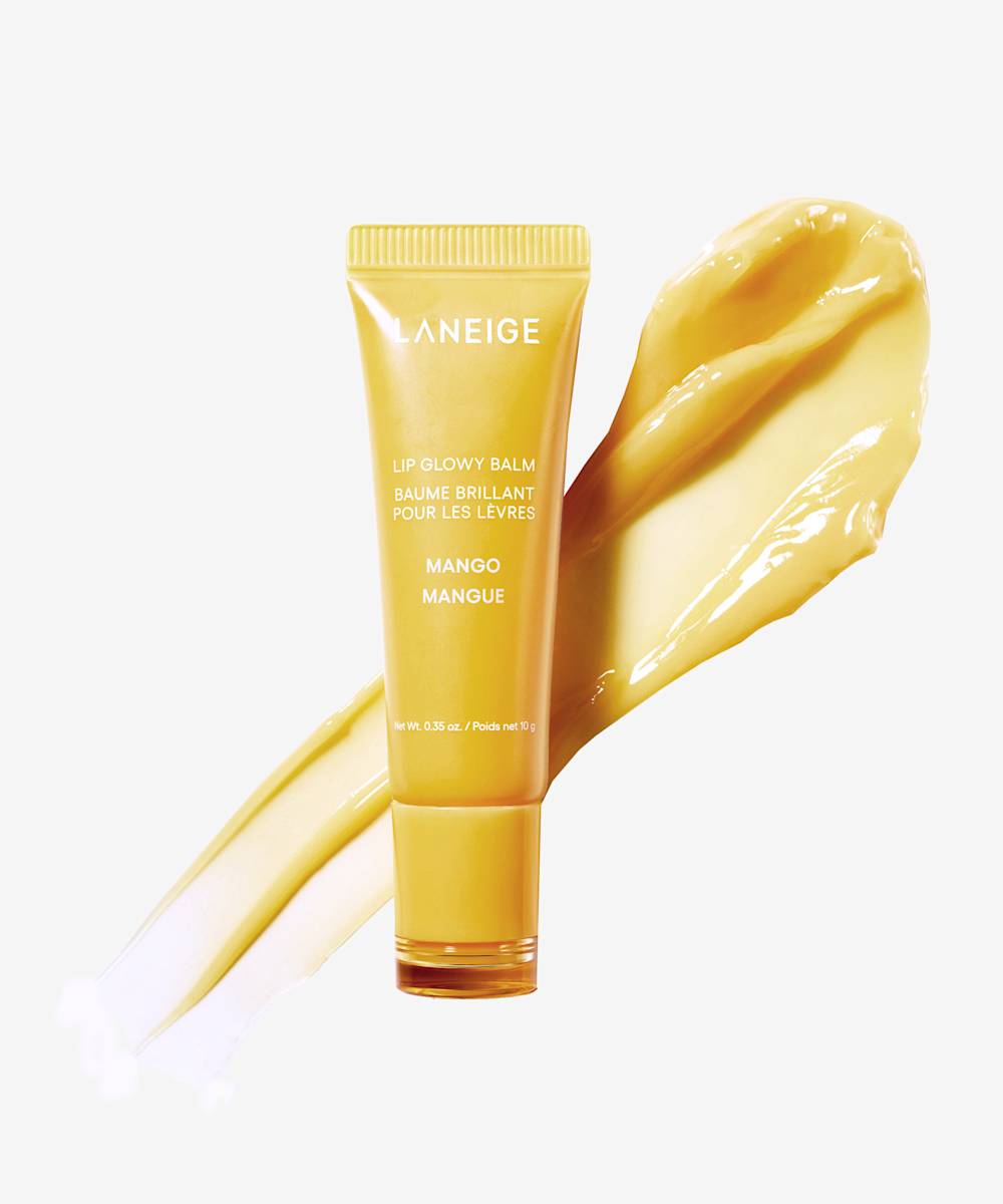 A yellow tube of Laneige Lip Glowy Balm - Mango 10g is displayed, promising exquisite hydration, with mango-colored gloss artfully smeared beside it to showcase its rich texture and consistency.