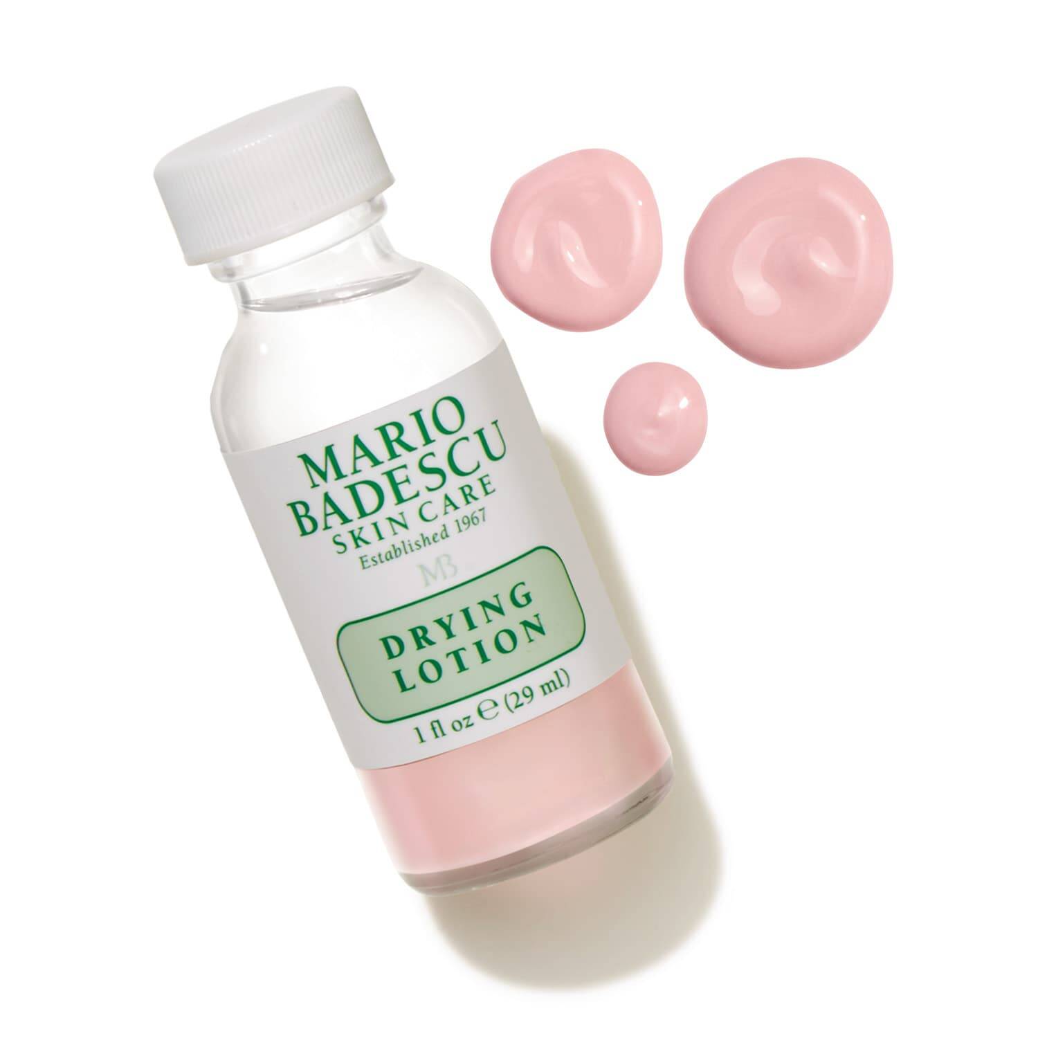 Mario Badescu drying lotion bottle with pink lotion on a white background