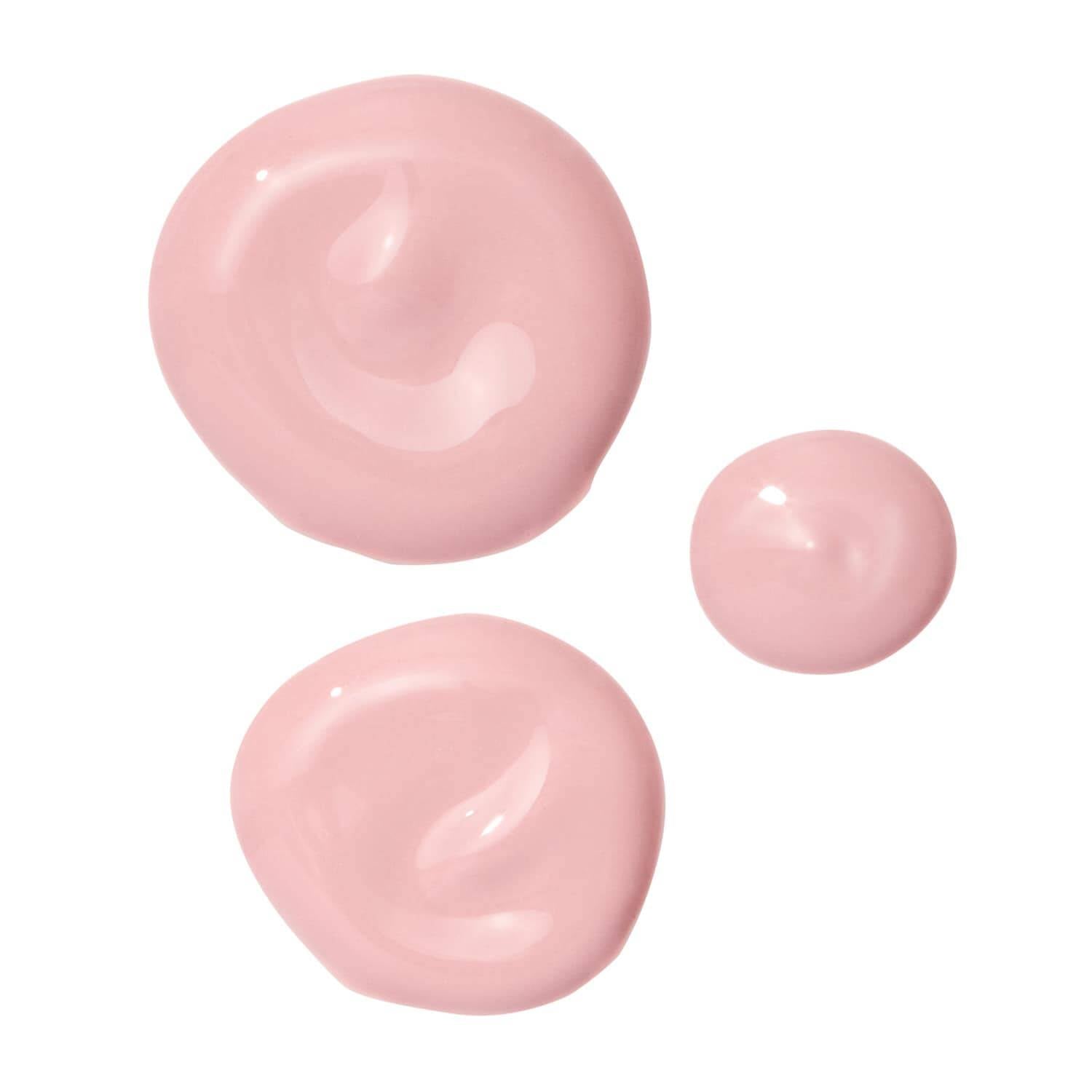 Three pink lip balm tubes on a white background