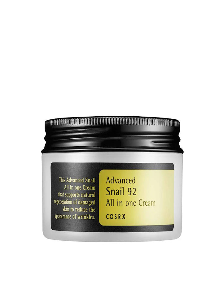 A 100g jar of COSRX Advanced Snail 92 All in One Cream with a black lid features a yellow and white label that promotes its snail mucin formula, emphasizing anti-aging benefits like wrinkle reduction, skin regeneration, and moisturizing effects.