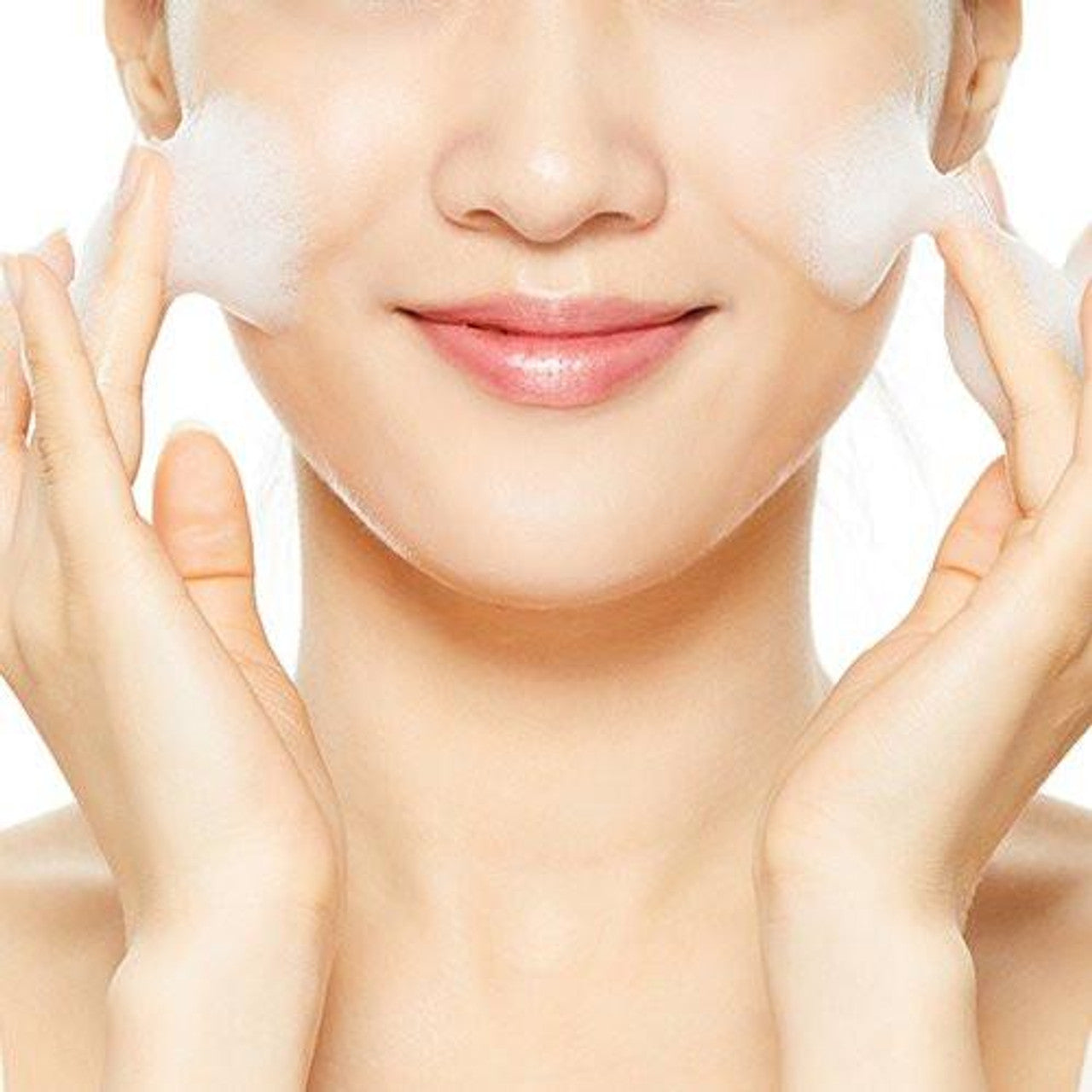 A person is gently cleansing their face with COSRX Low PH Good Morning Gel Cleanser, a vegan and cruelty-free product. They focus on the cheeks with a slight smile on smooth skin—its low pH formula enhances the experience against a plain white background, highlighting the face-washing activity.