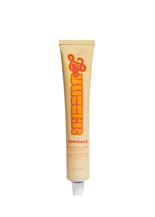 Topicals Like Butter Hydrating Moisturizer in a 50 mL (1.7 fl oz) beige squeeze tube with bold orange and red typography. The packaging highlights its purpose for dry, eczema-prone skin. The tube is slightly open with the cap removed, showcasing the product's functional design.