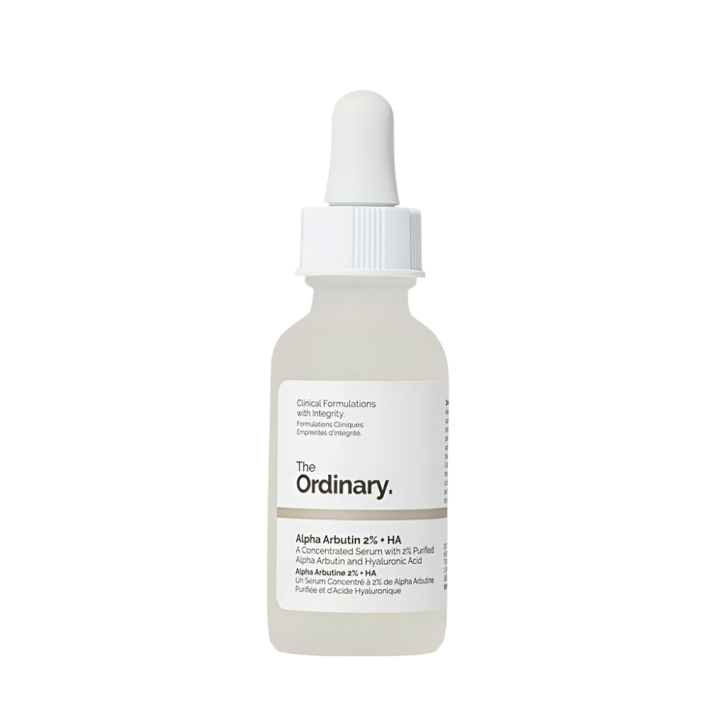 A white dropper bottle of The Ordinary Alpha Arbutin 2% + HA Serum 30ml targets hyperpigmentation, featuring the brand name and product details on the label. The cap includes a dropper for application against a plain white background.