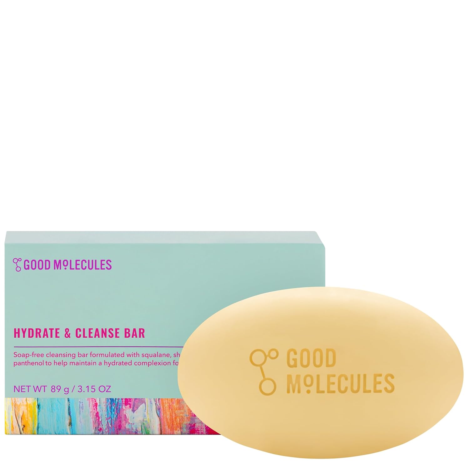 Close-up of a natural bar of soap, rectangular with beveled edges, in a beige color with subtle textured details. The soap is displayed against a white background, showcasing its minimalist and organic design