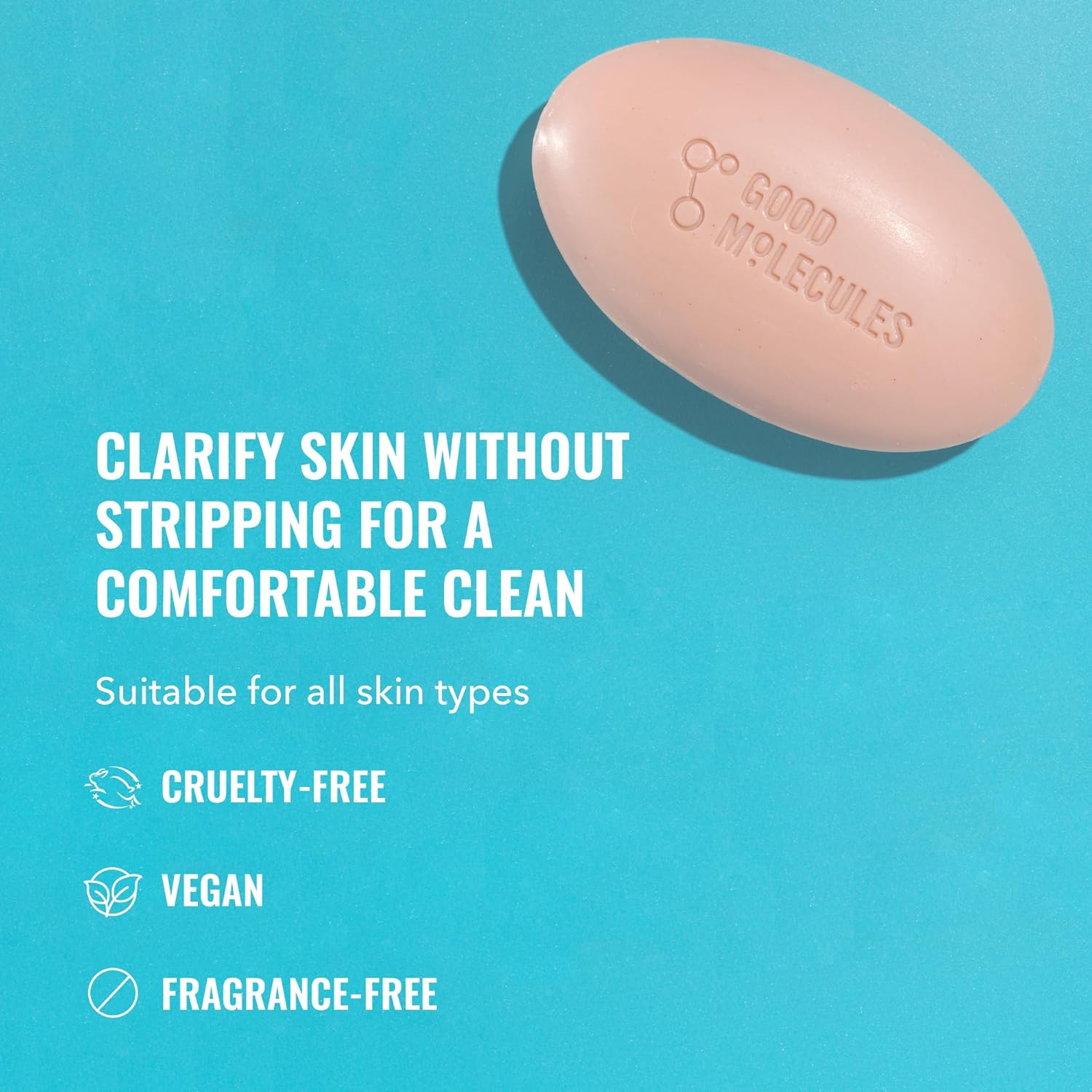 The Good Molecules Clarify & Cleanse Bar - 89g, embossed with the brand name, rests on a turquoise background. Infused with tea tree oil, it offers a comfortable clean without stripping, is cruelty-free, vegan, and fragrance-free—ideal for all skin types.