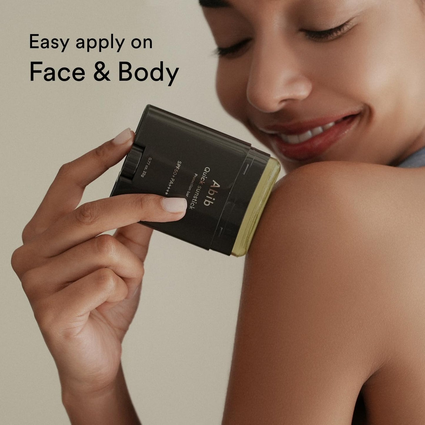 A person smiles while applying the Abib Quick Sunstick Protection Bar SPF50+ PA++++ to their shoulder. Text reads, Easy apply on Face & Body. The product is in a dark container with visible light green content, enhancing skin barrier strength.