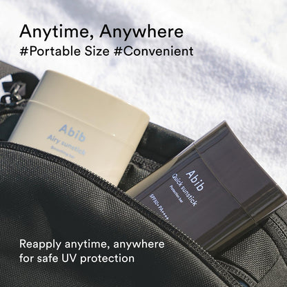 Two Abib Quick Sunstick Protection Bars SPF50+ PA++++ are visible from a black bag on a white background. Text reads: Anytime, Anywhere #SPF50+ PA++++ #Convenient and Reapply anytime for safe UV protection with Korean sunstick that strengthens your skin barrier.