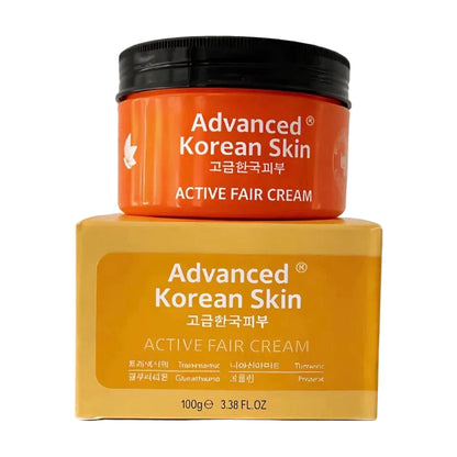 Advanced Korean Skin Active Fair Cream shown in an orange jar with a black lid, placed on top of its yellow-orange packaging box against a plain white background.