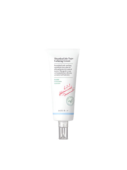 A 60ml white tube of AXIS-Y Heartleaf My Type Calming Cream, featuring a silver cap and a label with green and pink text, emphasizes centella asiatica for soothing hydration.