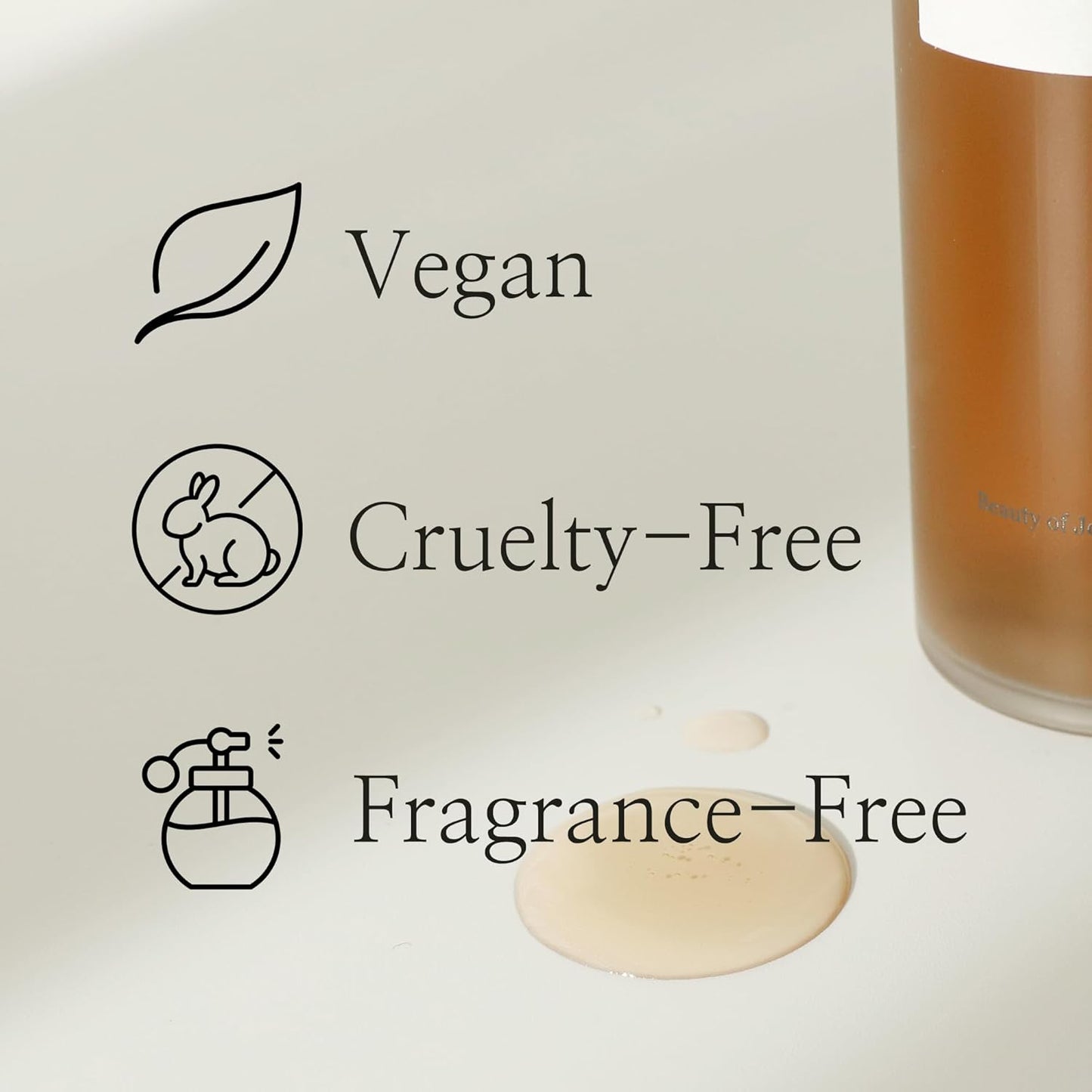 Close-up of a Beauty of Joseon Ginseng Essence Water Toner bottle on a light surface with spilled liquid. Icons and text read: Vegan with a leaf, Cruelty-Free with a rabbit, and Fragrance-Free—ideal for achieving the glass skin effect inspired by Korean beauty rituals.