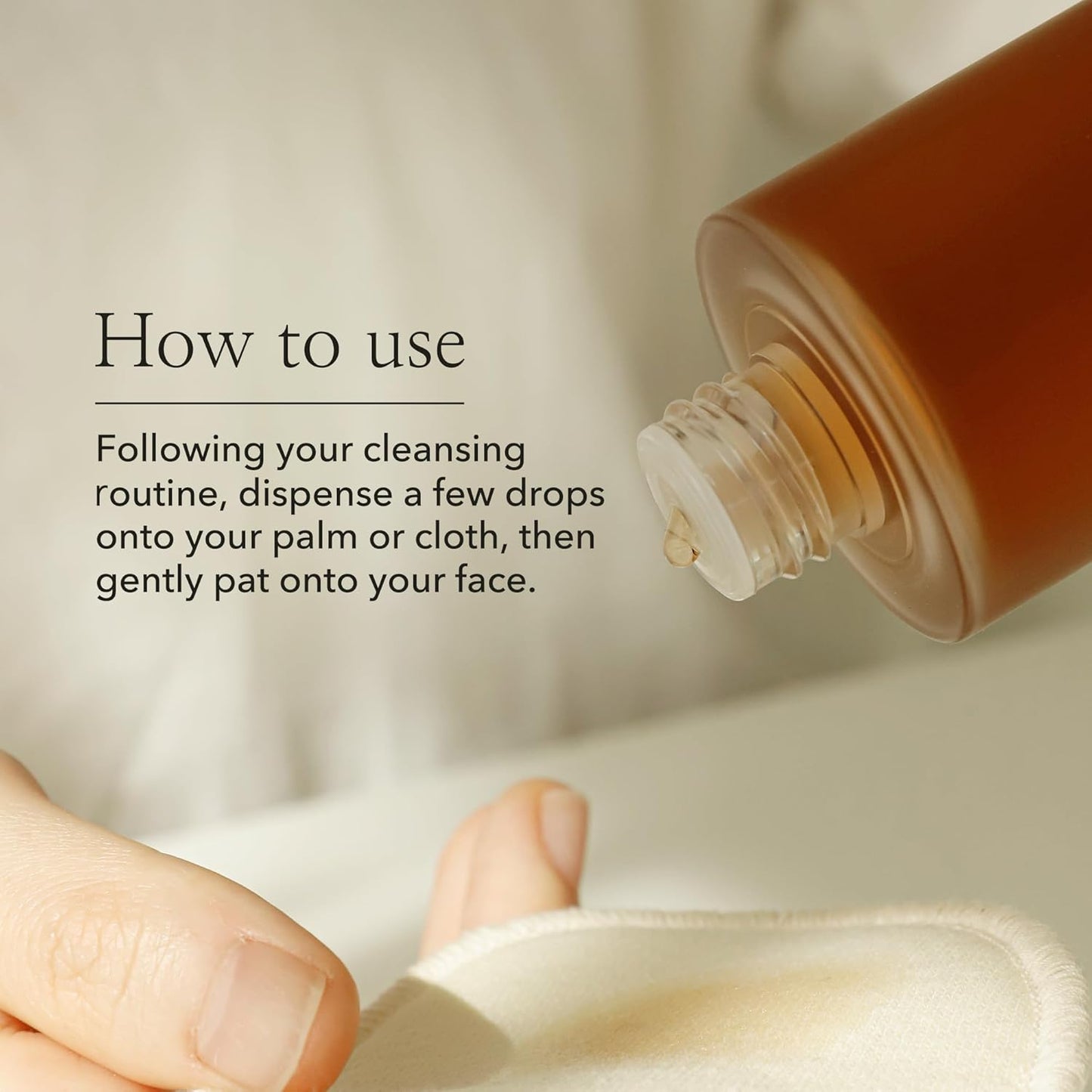 A brown bottle dispenses liquid onto a white cloth with text: Beauty of Joseon Ginseng Essence Water Toner - 150ml. After cleansing, pat a few drops onto your palm or cloth, then gently apply to the face for that glass skin look.