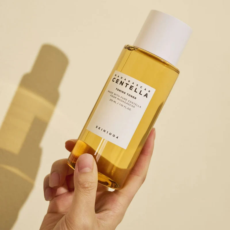  A close-up shot highlighting the clear bottle filled with the golden-hued toner, emphasizing its purity and simplicity.