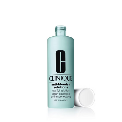 A light blue 200ml bottle of Clinique Anti-Blemish Solutions Clarifying Lotion, an exfoliating toner for acne by Clinique with a white cap, lies next to it on a white background.