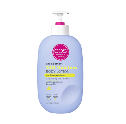 The image shows the eos Shea Better 24H Moisture Body Lotion in Vanilla Cashmere, a sustainable skincare product. It has a light blue bottle, white pump top, and contains 473ml (16 fl. oz.). Enriched with 7 nourishing oils and butters, it provides lasting hydration for dry skin.