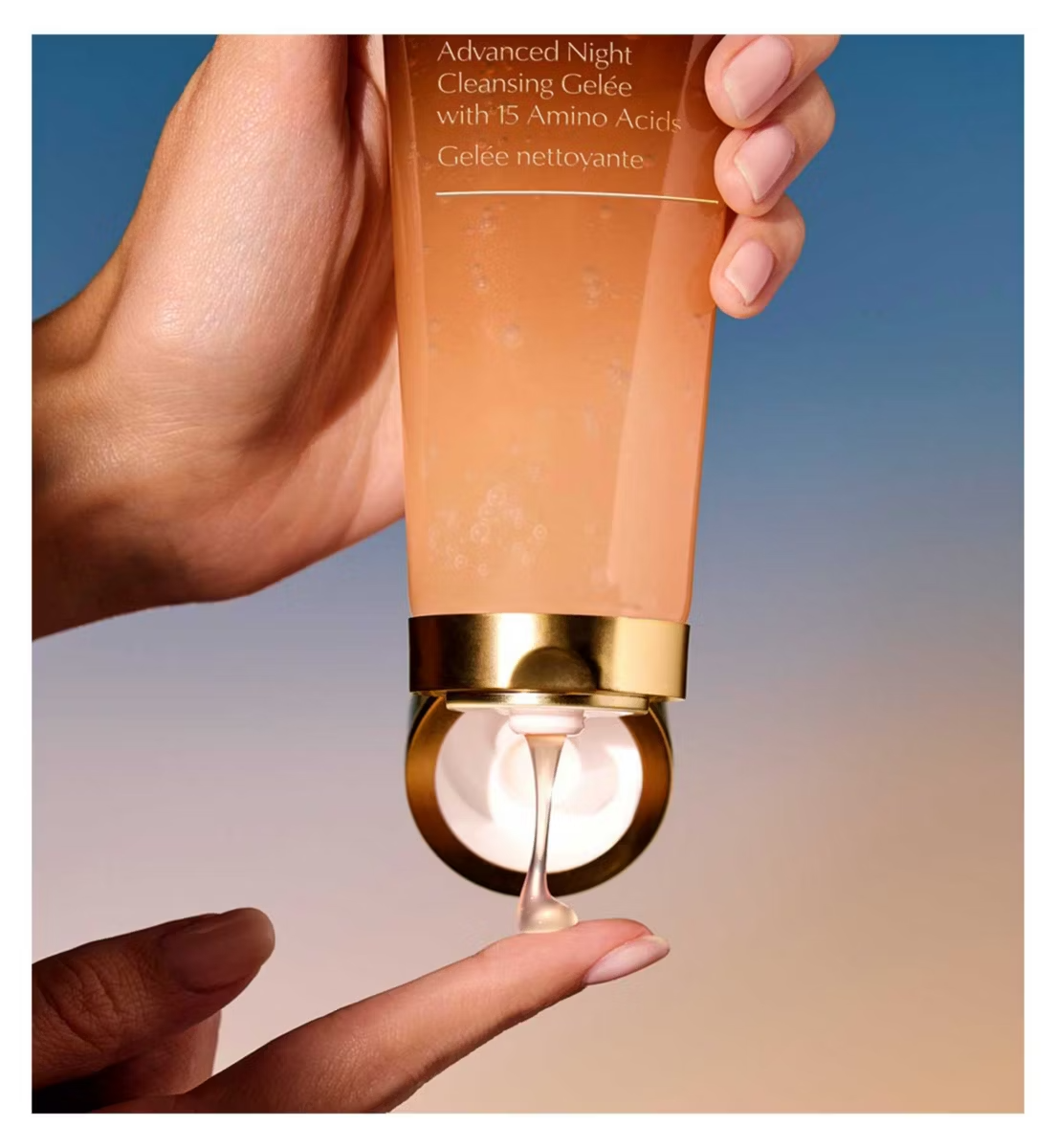 Hand holding a tube of Advanced Night Cleansing Gelee with a blurred background