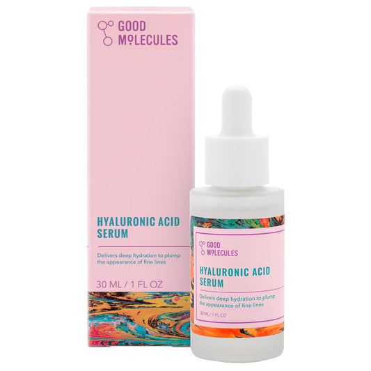 A Good Molecules Hyaluronic Acid Serum dropper bottle (30ML/1 FL OZ) stands before its pink box. Abstract designs on the label emphasize its moisturizing power for radiant skin.