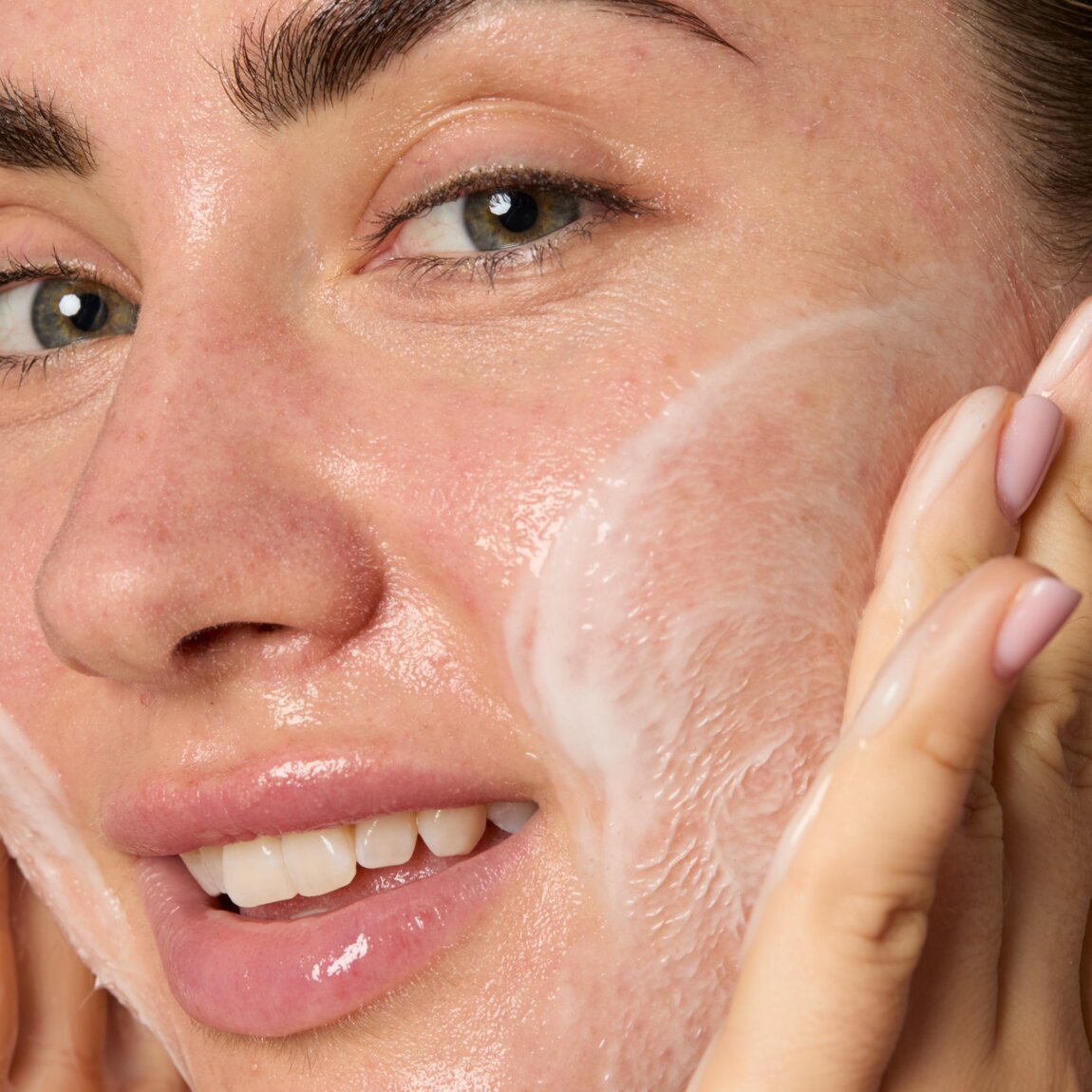 Woman applying a skincare product to her face