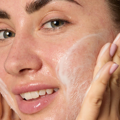 Woman applying a skincare product to her face