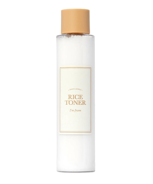 A clear bottle with a beige cap contains white liquid infused with rice extract. The label reads IM FROM Rice Toner and highlights hydrating properties, mentioning Seoul, Korea. Glow Essence & Niacinamide, 150ml by Im From.