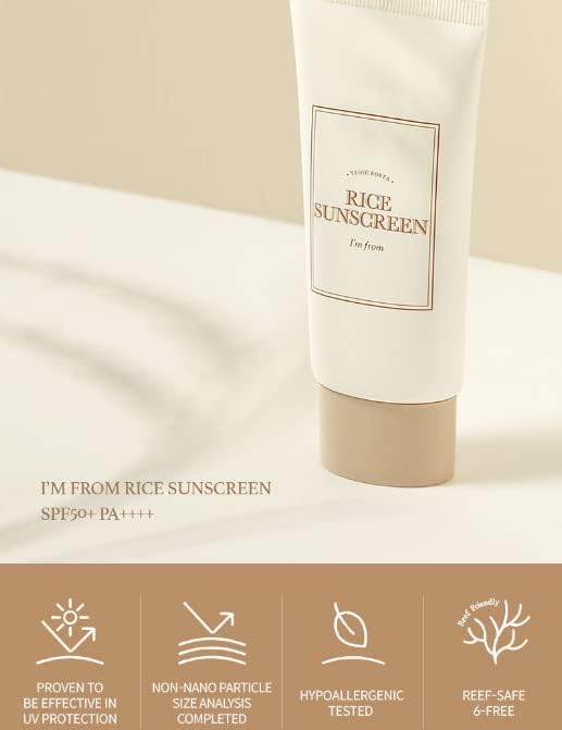 A tube of Im From Rice Sun Screen SPF50+ PA++++ sits on a light surface. This mineral sunscreen, with non-nano particles and hypoallergenic, reef-safe ingredients, offers strong UV protection. The cream-colored tube has a beige cap.