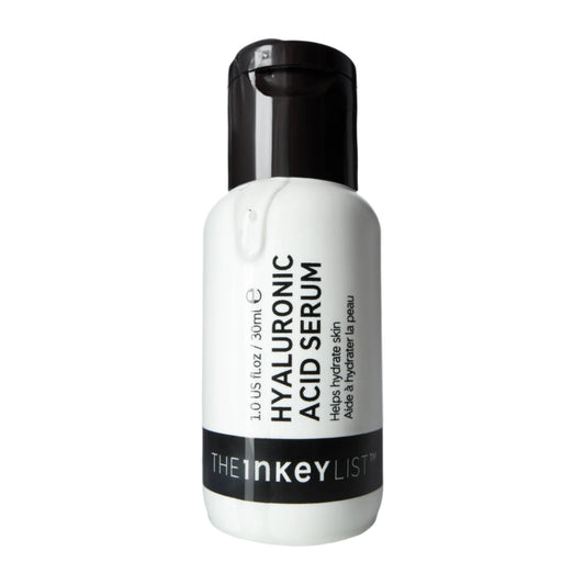 The Inkey List™ Hyaluronic Acid Serum features a white bottle with a black cap, brand name on a black stripe, and offers moisture-binding properties ideal for reducing fine lines. Contains 1.0 US fl oz / 30ml.