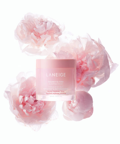 A jar of Laneige Bouncy & Firm Sleeping Mask - 60ml is surrounded by soft pink peonies. The mask promises to plump, hydrate, and enhance skin radiance. The background is a light, neutral color.