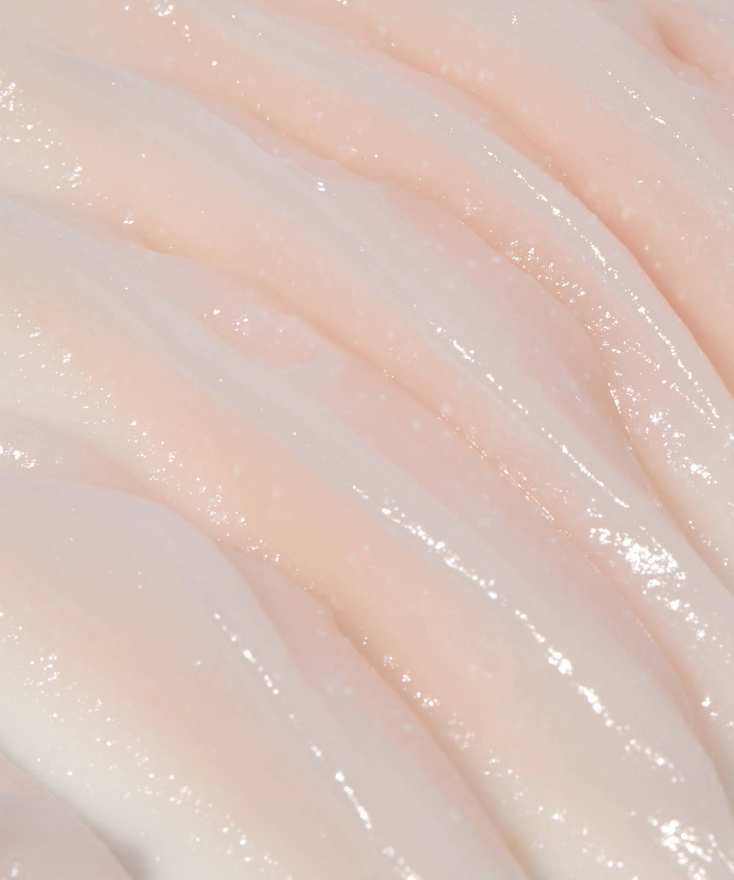 The Laneige Bouncy & Firm Sleeping Mask features a creamy, smooth surface with a light pink hue. Its wavy, glossy texture mirrors luxurious cream layers, reflecting light beautifully to enhance skin radiance and vitality.