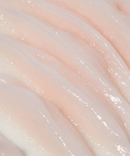 The Laneige Bouncy & Firm Sleeping Mask features a creamy, smooth surface with a light pink hue. Its wavy, glossy texture mirrors luxurious cream layers, reflecting light beautifully to enhance skin radiance and vitality.
