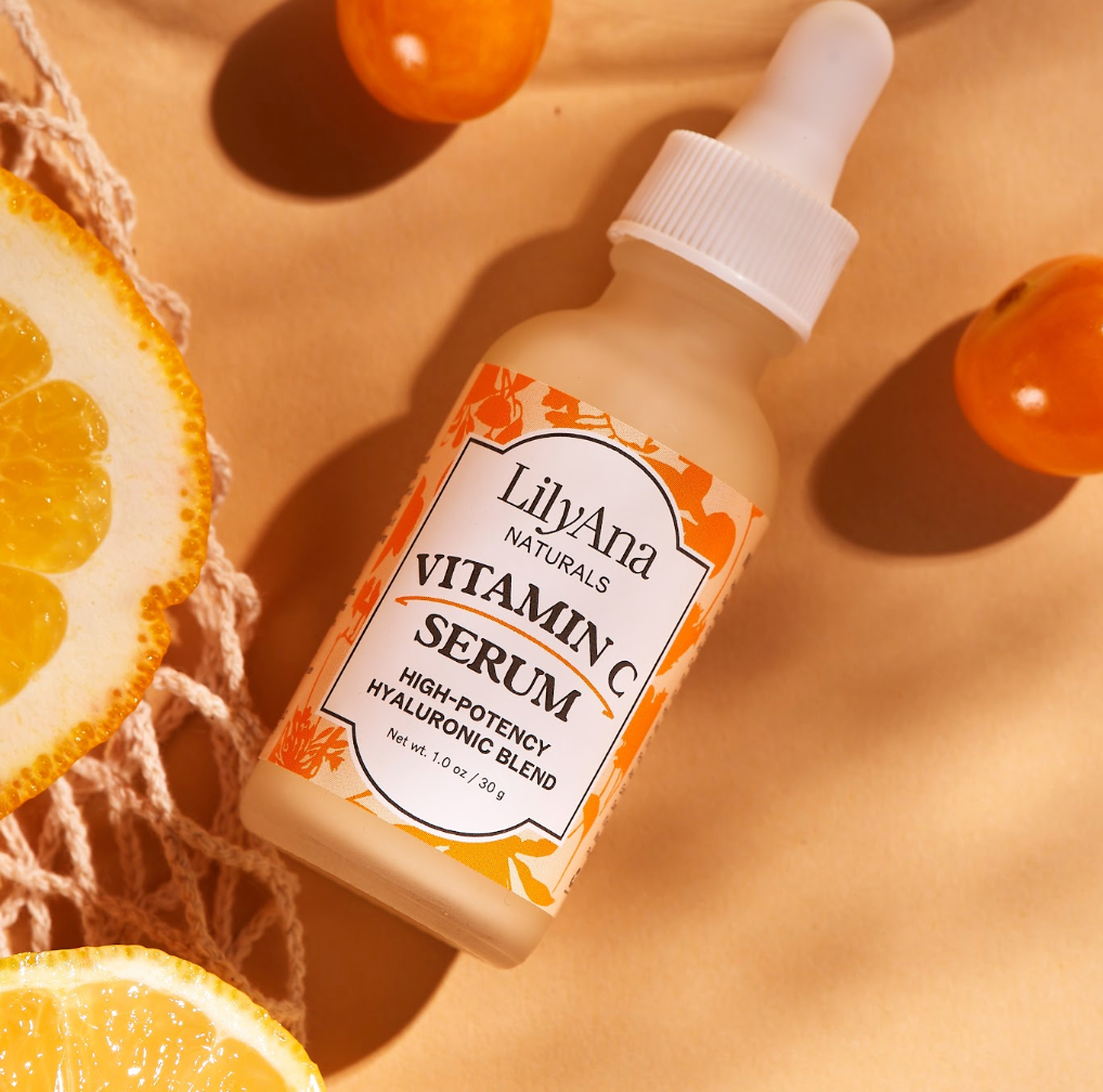 LilyAna Naturals Vitamin C Serum bottle with oranges on a beige background