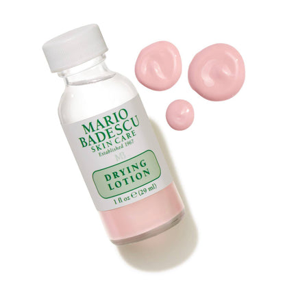 Mario Badescu drying lotion bottle with pink lotion on a white background