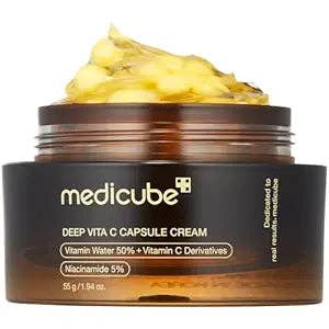 Medicube Deep Vita C Capsule Cream jar with yellow cream on a white background
