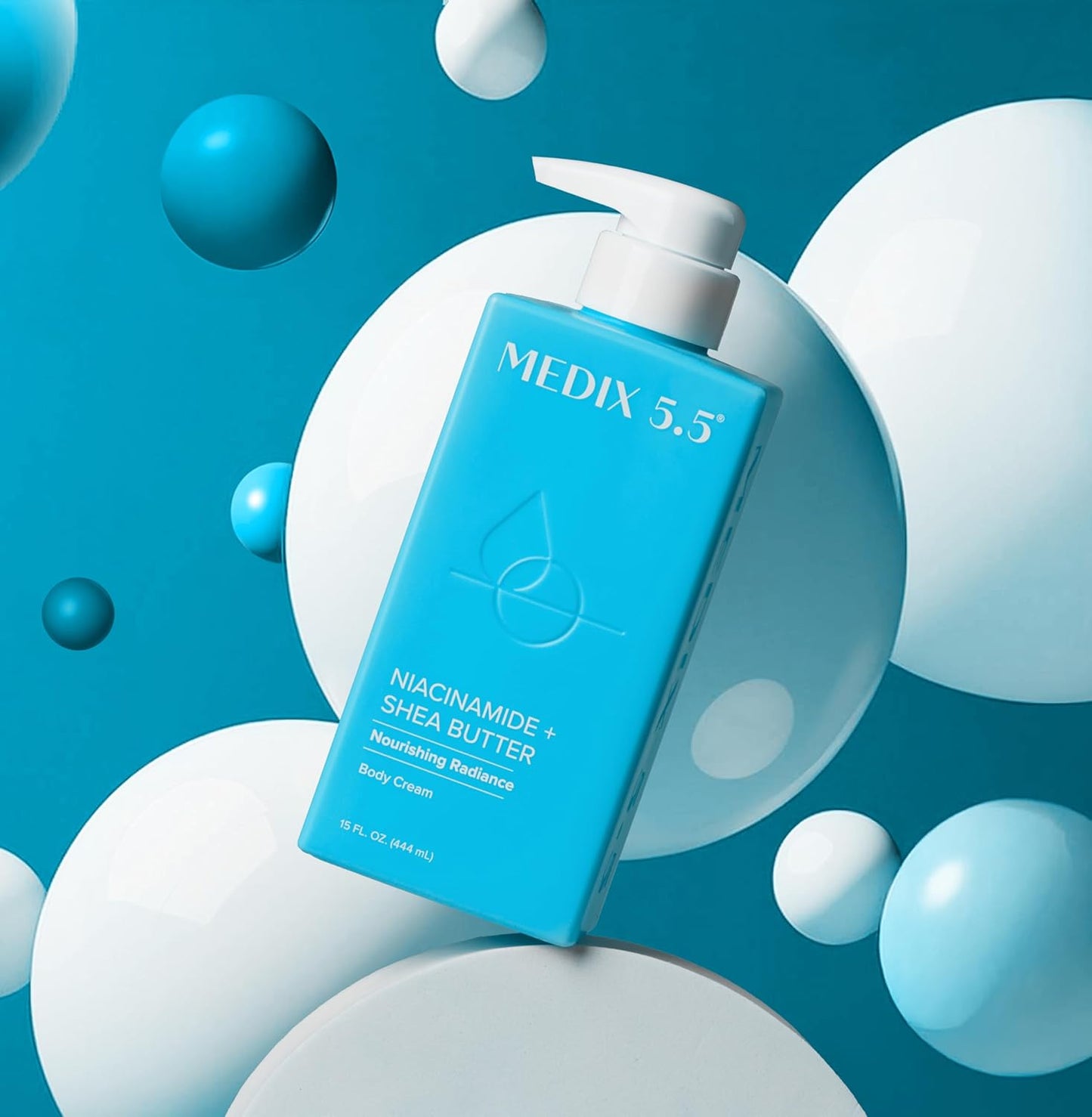 A blue bottle of MEDIX 5.5 Niacinamide + Shea Butter Body Cream (New) with a pump dispenser stands against a blue background, glowing with nourishing radiance amid floating white and blue spheres.
