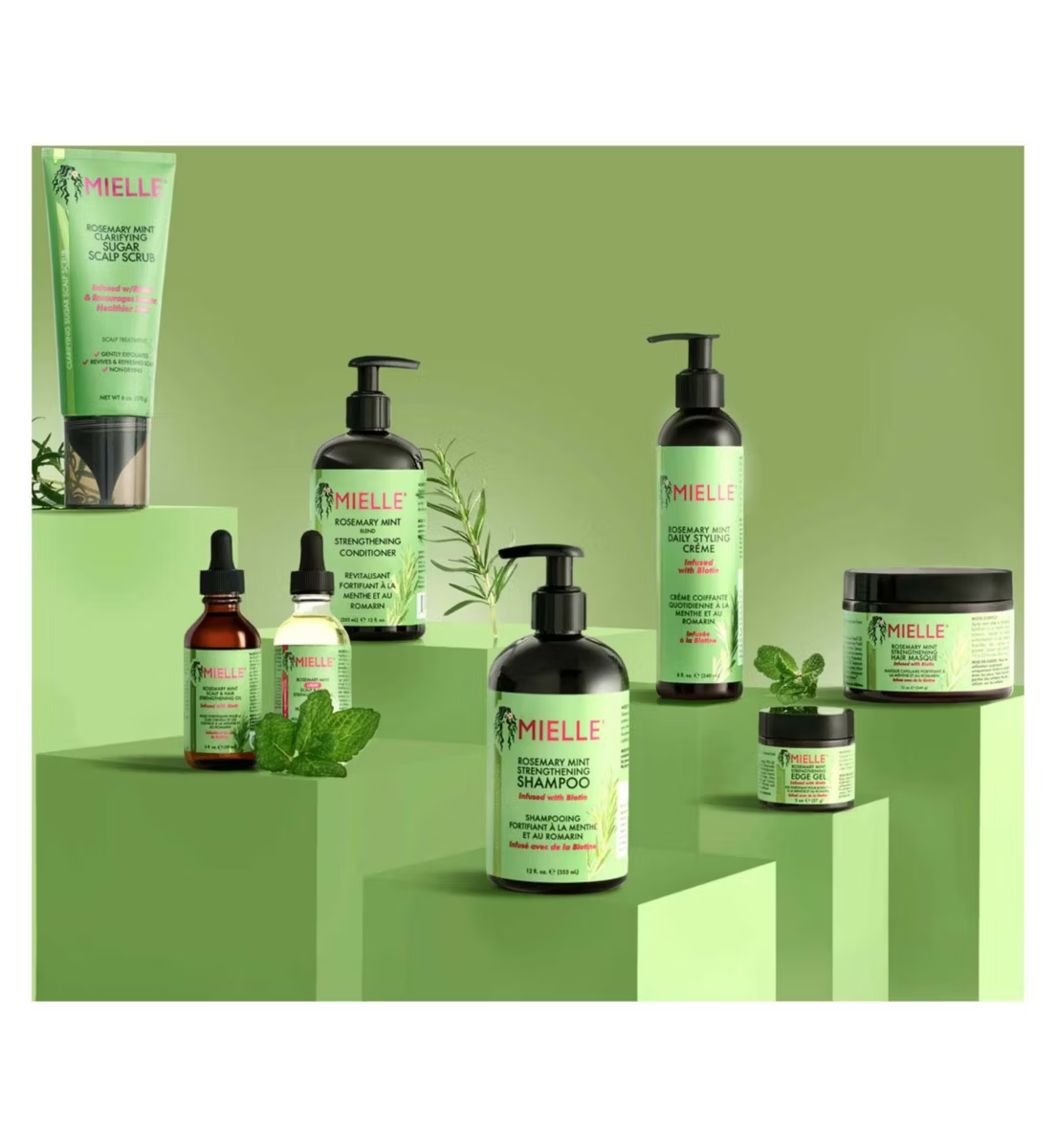 Mielle Organics hair care products on a green background
