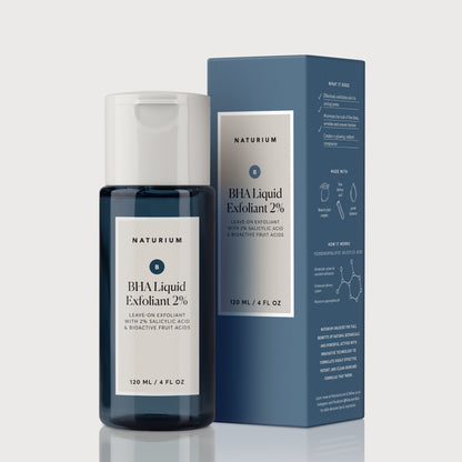 A blue bottle of Naturium BHA Liquid Exfoliant 2% (120ml) – Pore Refining Exfoliant stands by its matching box, both showing product details. This formula from Naturium helps unclog pores for smoother, clearer skin.