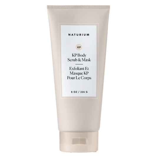 A beige tube of NATURIUM KP Scrub & Mask 226g stands upright, featuring minimalist English and French labels. This body exfoliator is designed for keratosis pilaris and showcases a chic, simple look.