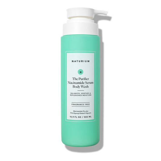 A green 500ml bottle of NATURIUM The Purifier Niacinamide Serum Body Wash with a white pump. This fragrance-free cleanser balances, soothes, and replenishes moisture for clarified skin.