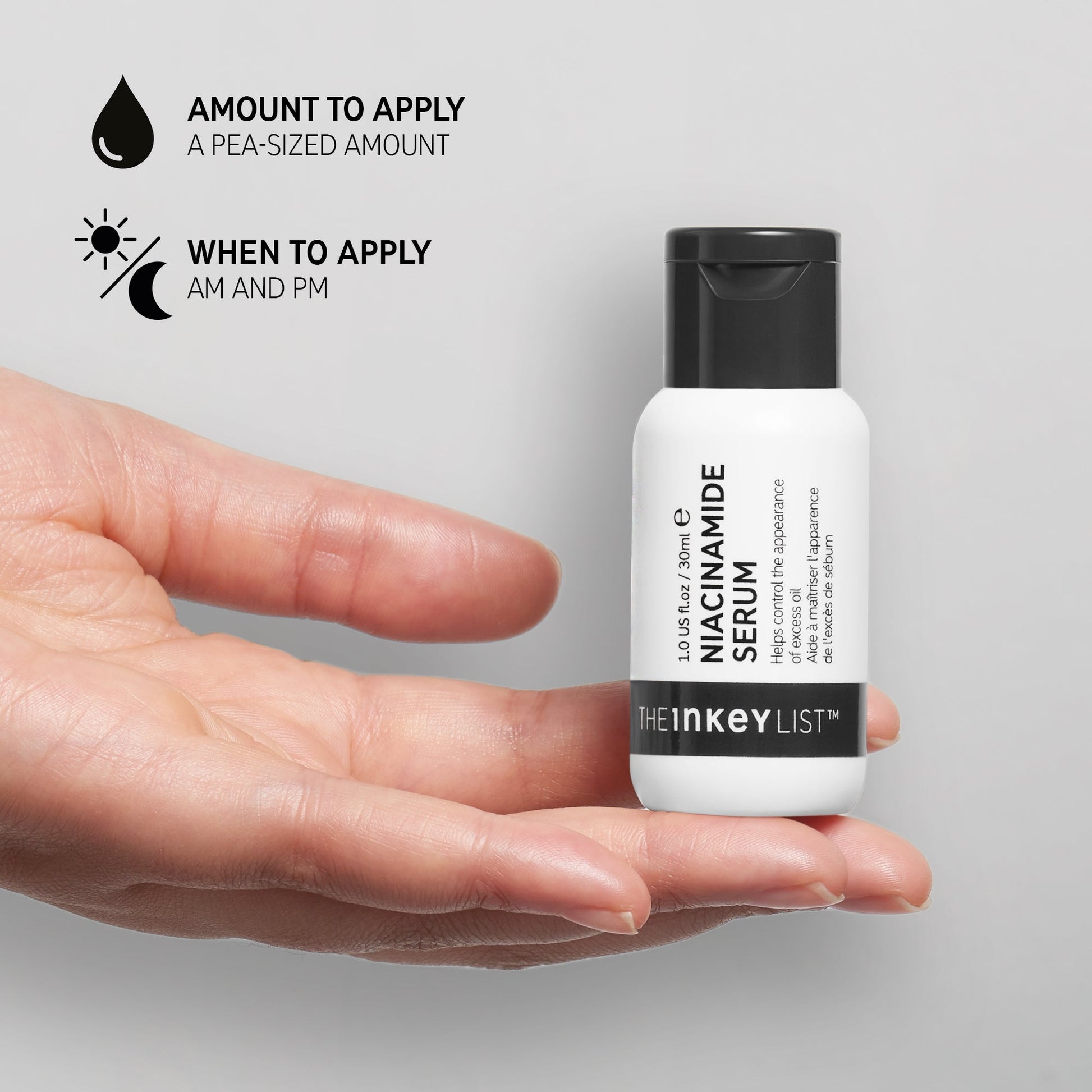 A hand holds a small bottle of The INKEY List™ Niacinamide Serum 30ml, ideal for acne-prone skin. Use a pea-sized amount in the morning and evening for optimal results.