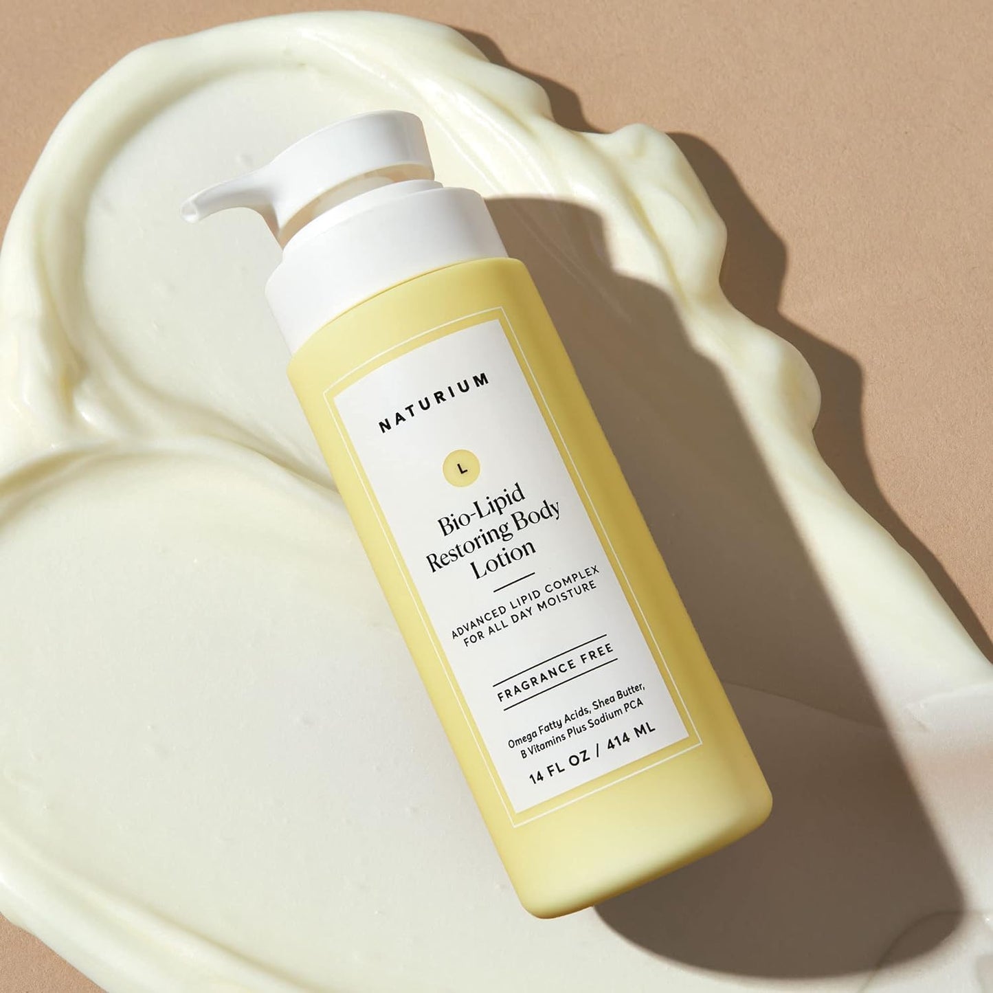 Naturium Bio-Liquid Restoring Body Lotion bottle with lotion spilled on a beige background