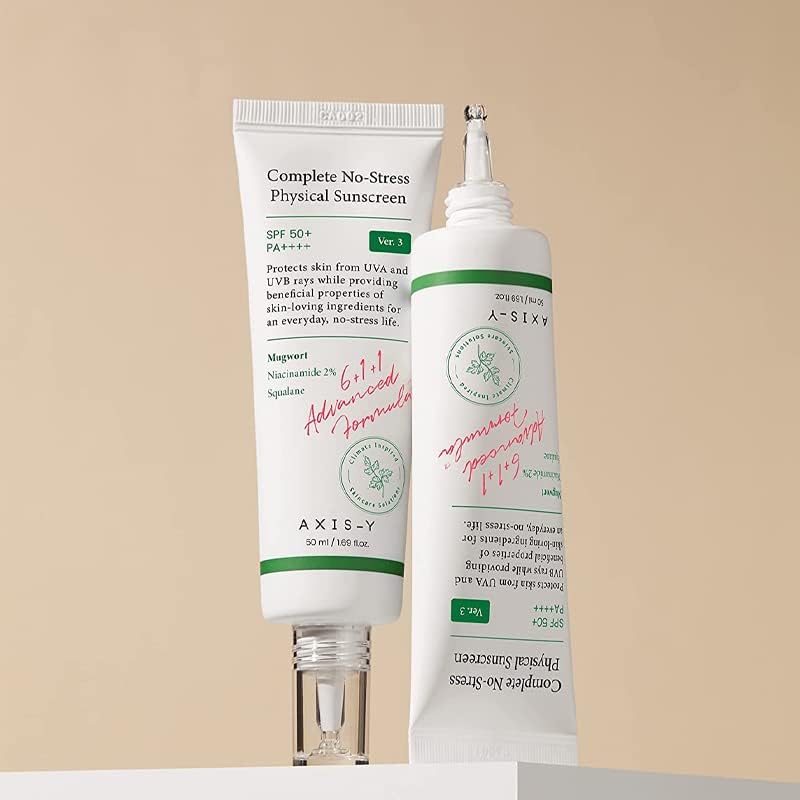 Two tubes of Axis-Y Complete No-Stress Physical Sunscreen 50ml on a beige background. Infused with mugwort and niacinamide, one tube is upright with its cap off, while the other leans diagonally, highlighting both text and elegant design. Brand: AXIS - Y.