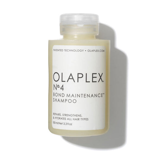 A 100ml bottle of OLAPLEX No.4 Bond Maintenance Shampoo from the 3-4-5 System stands upright on a white background with a clear cap, white label, black text, and a soft shadow—formulated to repair broken bonds.